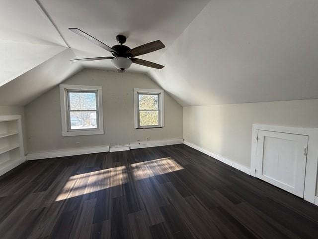 bonus room with ceiling fan, lofted ceiling, built in features, and dark hardwood / wood-style flooring