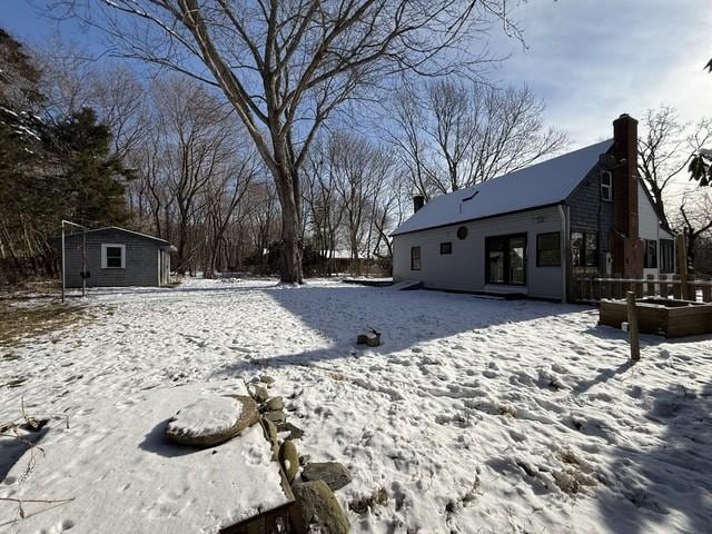 yard covered in snow with an outdoor structure