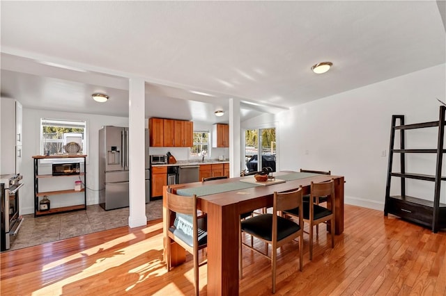 dining room with sink and light hardwood / wood-style floors