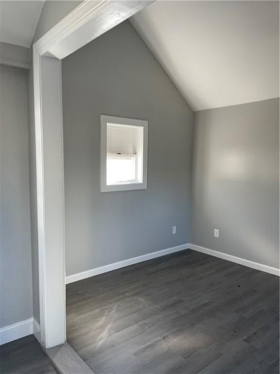 bonus room featuring dark hardwood / wood-style floors and vaulted ceiling