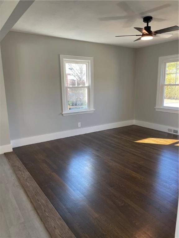 spare room with ceiling fan and dark hardwood / wood-style flooring