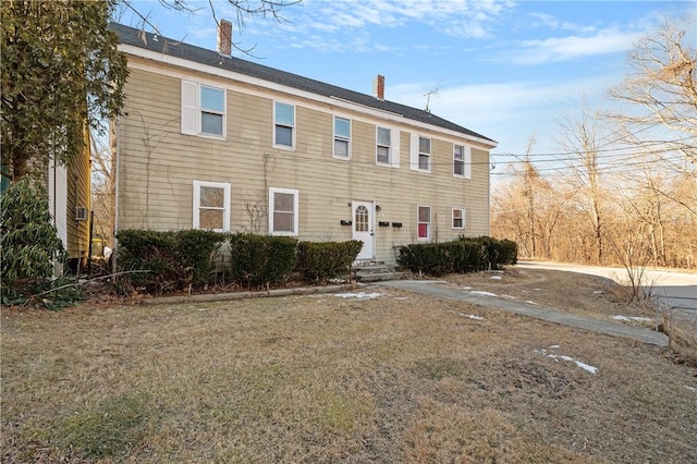 colonial home with a front lawn