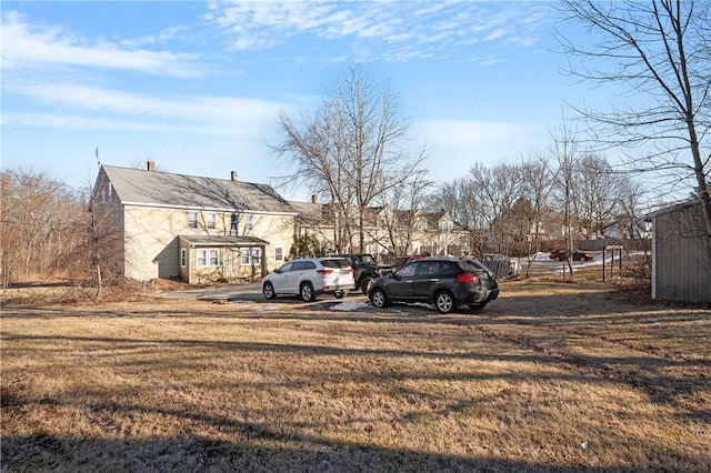 view of parking / parking lot featuring a yard