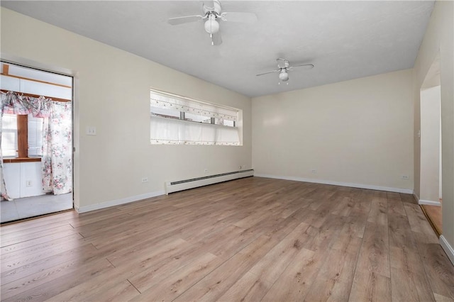 unfurnished room with ceiling fan, light wood-type flooring, and a baseboard heating unit