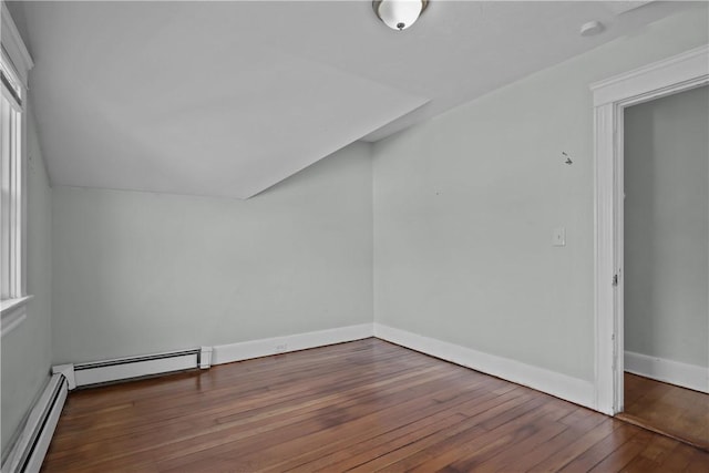 additional living space with dark hardwood / wood-style flooring, lofted ceiling, and baseboard heating