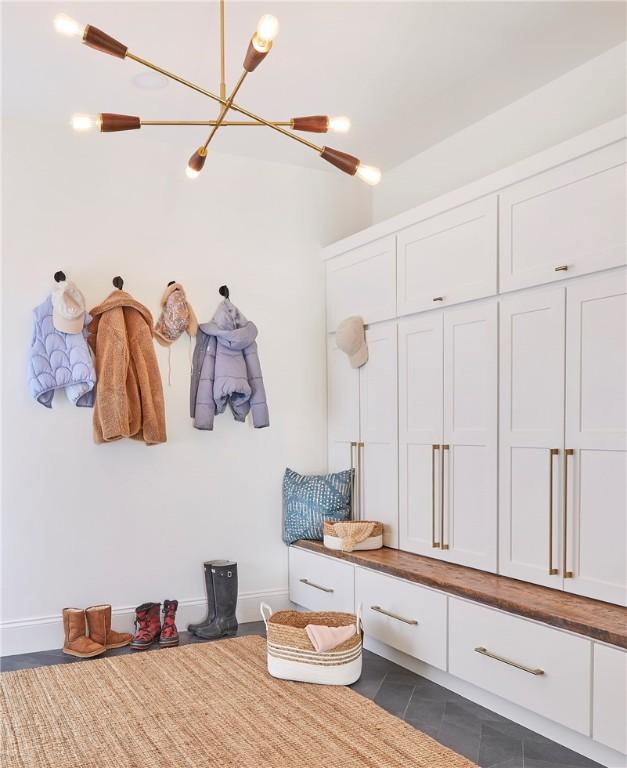 mudroom featuring dark tile patterned flooring