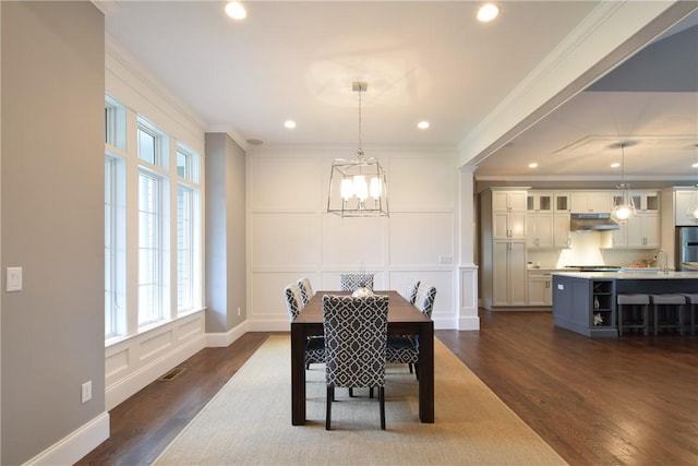 00 Tipping Rock Dr, East Greenwich, RI 02818 - dining area with a notable chandelier, crown molding, dark wood-type flooring, and sink