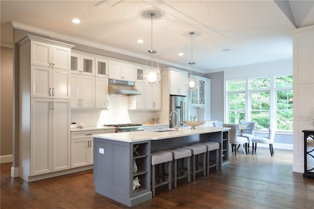 00 Tipping Rock Dr, East Greenwich, RI 02818 - kitchen featuring an island with sink, appliances with stainless steel finishes, white cabinets, and decorative light fixtures