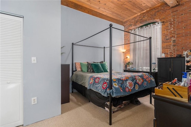 bedroom with brick wall, light carpet, and wooden ceiling