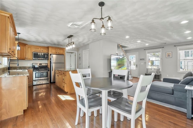 dining area with hardwood / wood-style flooring and sink