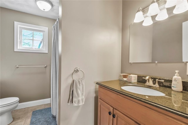 bathroom with vanity, tile patterned floors, and toilet