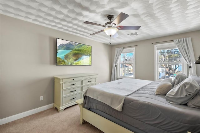 bedroom featuring light carpet and ceiling fan