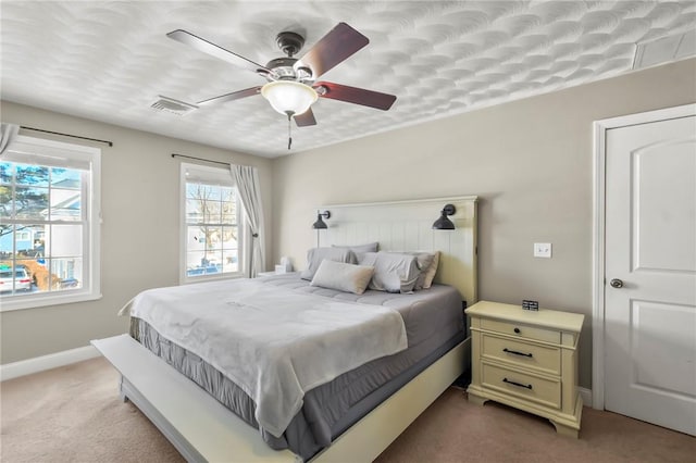 bedroom featuring light carpet and ceiling fan