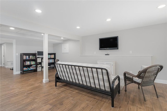 sitting room featuring baseboards, wood finished floors, and recessed lighting