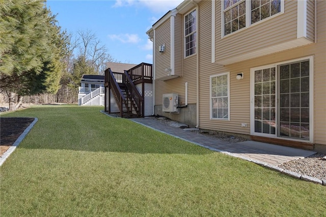 view of yard with a deck, ac unit, and stairway