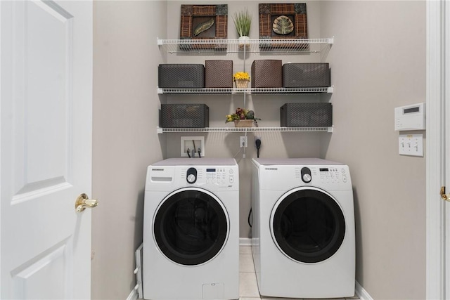 washroom with laundry area, light tile patterned flooring, and separate washer and dryer