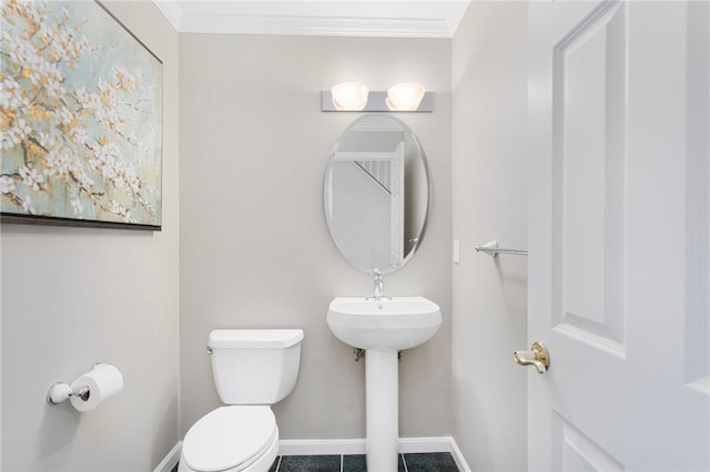 bathroom with ornamental molding, baseboards, and toilet