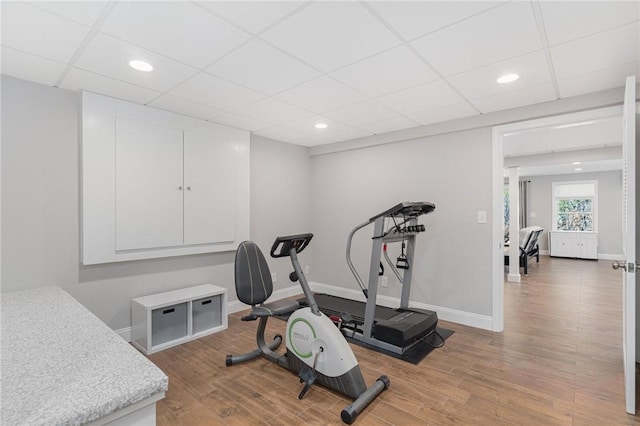 exercise area featuring recessed lighting, baseboards, and light wood finished floors