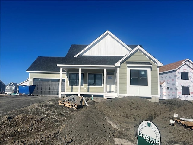 view of front of property featuring aphalt driveway and an attached garage