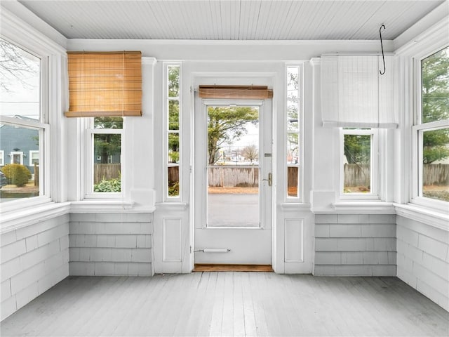 unfurnished sunroom featuring wood ceiling