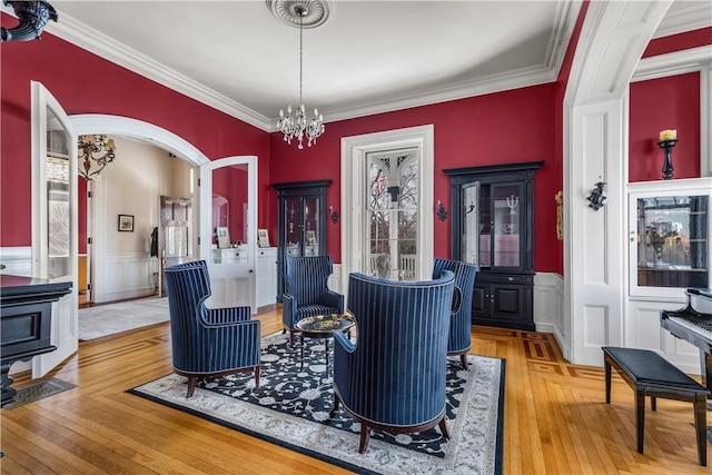 dining area featuring crown molding, an inviting chandelier, and hardwood / wood-style floors