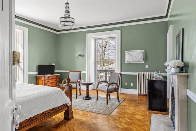 bedroom featuring crown molding, radiator, an inviting chandelier, and light parquet floors