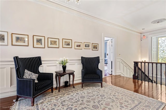 living area featuring crown molding and wood-type flooring