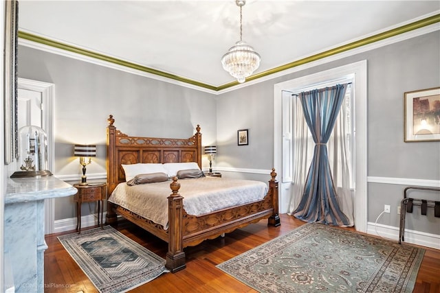 bedroom featuring crown molding, a notable chandelier, and hardwood / wood-style flooring