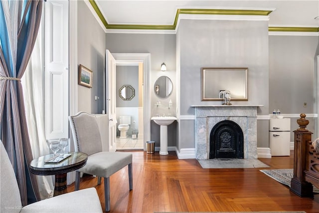 living area with ornamental molding and a premium fireplace