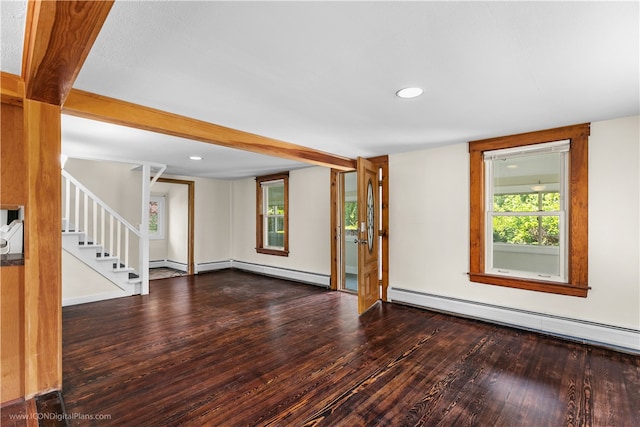 spare room featuring wood-type flooring and a baseboard heating unit