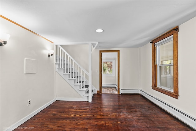 foyer featuring a baseboard heating unit and dark hardwood / wood-style floors