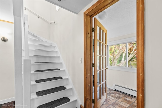 staircase featuring a baseboard radiator