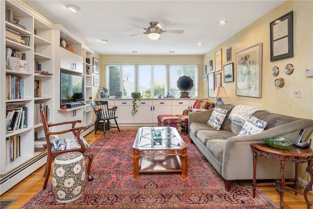 living room featuring light hardwood / wood-style flooring, ceiling fan, and baseboard heating