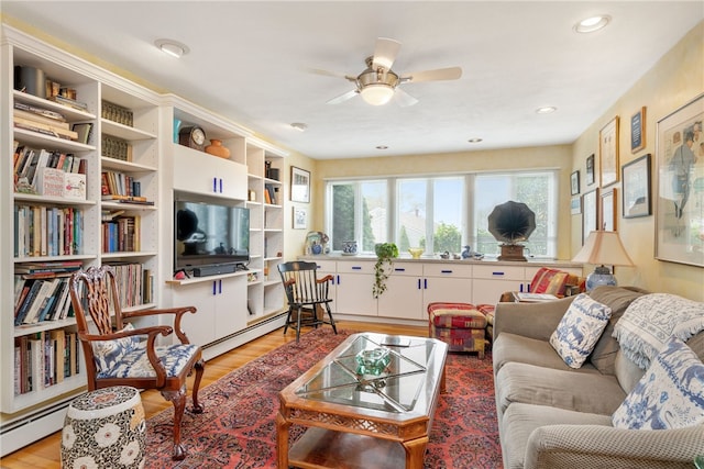 living room with ceiling fan, a baseboard radiator, and light wood-type flooring