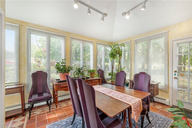 sunroom / solarium featuring vaulted ceiling, a wealth of natural light, and a baseboard radiator