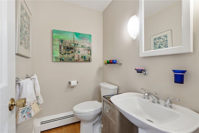 bathroom featuring a baseboard radiator, sink, and toilet