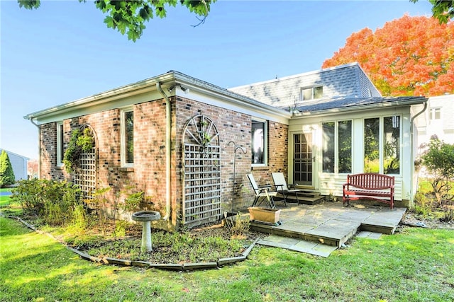 back of house with a lawn and a patio area