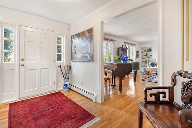 foyer entrance featuring a baseboard radiator and wood-type flooring