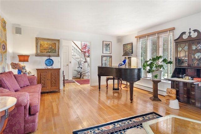 interior space with baseboard heating and light hardwood / wood-style flooring