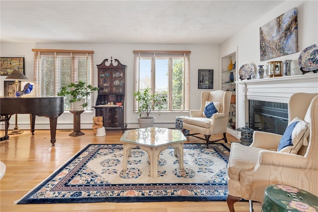 living room with a baseboard heating unit and hardwood / wood-style flooring