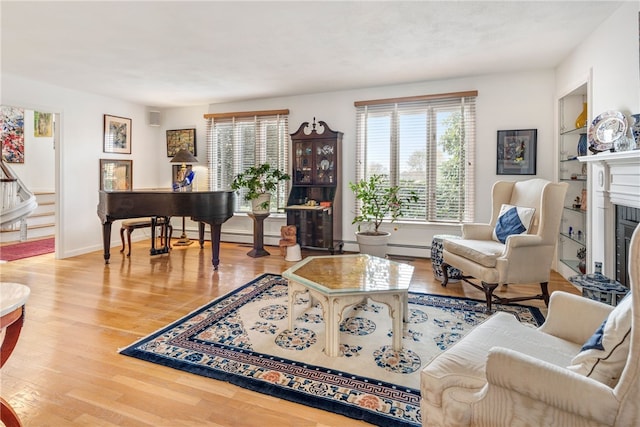 living room featuring baseboard heating and light hardwood / wood-style flooring