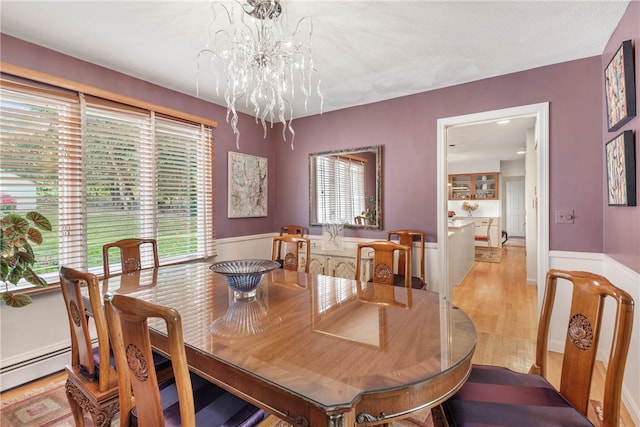 dining space with an inviting chandelier and light wood-type flooring