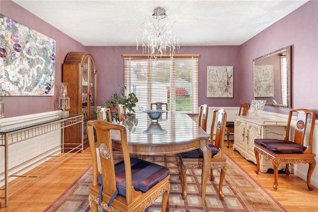 dining room with an inviting chandelier, a baseboard radiator, and hardwood / wood-style flooring