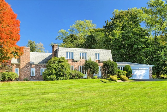 view of front facade with a garage and a front lawn