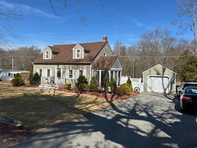 cape cod home with an outdoor structure, fence, a garage, and driveway