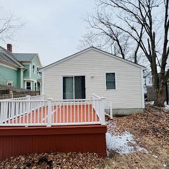 rear view of house featuring a wooden deck