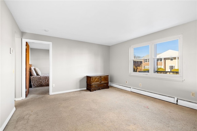 unfurnished room featuring light carpet and baseboard heating