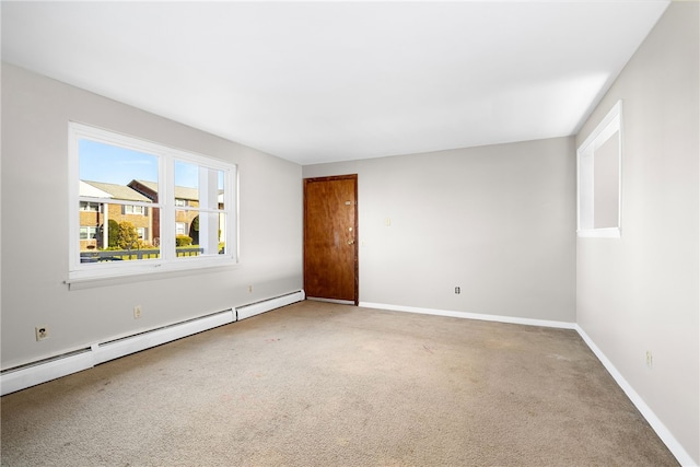 carpeted spare room with baseboard heating