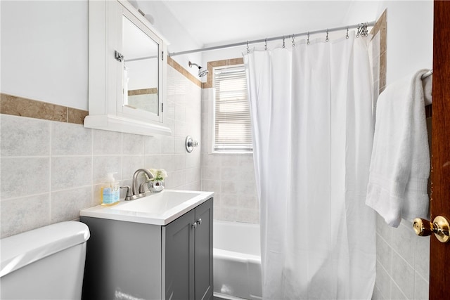 full bathroom with shower / bath combination with curtain, vanity, toilet, and tile walls