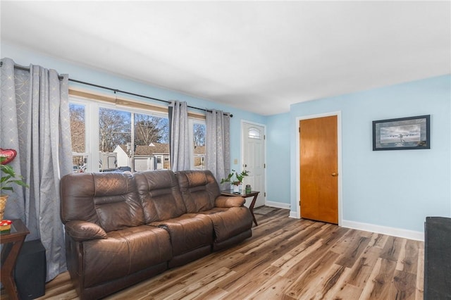 living room featuring baseboards and wood finished floors